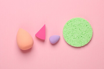 Wall Mural - Make-up sponge, cosmetic beauty blenders on pink background. Top view. Flat lay