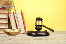 Law Concept - Open Law Book, Judge's Gavel, Scales On Table In A Courtroom Or Law Enforcement Office.