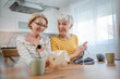 © Miljan Živković - two women senior mature knitting and embroidery during leisure time