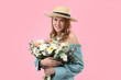 © New Africa - Beautiful woman in straw hat with bouquet of flowers on pink background