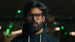 © Yuliia - Close up Indian shocked bearded guy in glasses astonished looking at camera at dark underground wonder amazed Arabian man shock fear scared say wow stunned big eyes open mouth bad news at parking lot