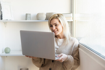 Wall Mural - People, lifestyle, modern technology and communication concept. Young Caucasian female working online