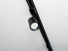 Background Led Track Lamp On The Ceiling In The Interior. Interior Spotlight In Black Color. Modern Track Lamp With A Lot Of Swivel Lamps. The Concept Of Lighting In The House.