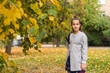 © Angelov - Cute young girl with a backpack heading to school on cold autumn morning.