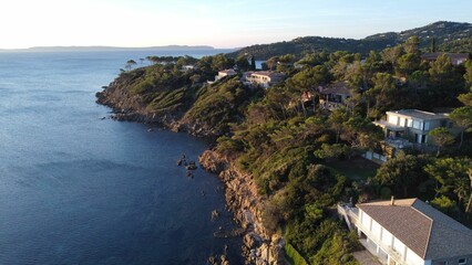 Canvas Print - Drone shot of the rocky coast of a green-covered island