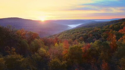 Wall Mural - Beautiful mountain view sunrise over Ozark Mountains with foggy valley and autumn colored trees shot via drone aerial