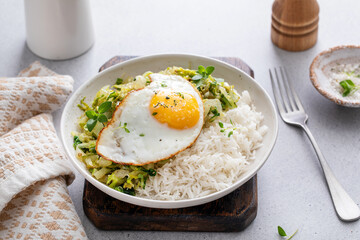 Wall Mural - Rice bowl with sauteed cabbage and fried egg, healthy lunch or breakfast idea