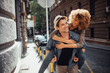 © Geber86 - Young man carrying his girlfriend on his back while on a date in the city