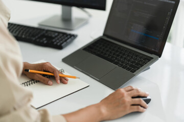 Wall Mural - developer programmer use mouse and checking code on laptop while programming to developing website