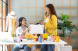© freebird7977 - Two Young women fashion designer using laptop working and received order customer for design tailor and cloth in the showroom,  Lifestyle Stylish tailor taking measurements on mannequin for cutting