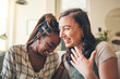 © Charlize Davids/peopleimages.com - Smile, funny and friends with women on sofa for relax, bonding and conversation. Happy, support and joke with people laughing in living room at home for gossip, chat and discussion together