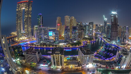 Wall Mural - Panoramic view of Dubai Marina with several boat and yachts parked in harbor and skyscrapers around canal aerial day to night timelapse.