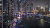 Fototapeta  - Panorama showing luxury yacht bay in the city aerial night timelapse in Dubai marina