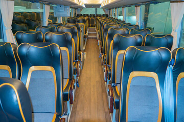 Bus interior. Vehicle with leather seats. Bus for long distance transportation. Intercity public transport interior. Bus with wooden parquet on floor. Corporate autobus without people