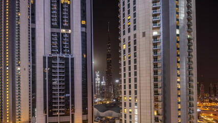 Wall Mural - Tallest skyscrapers in downtown dubai located on bouleward street near shopping mall aerial all night timelapse.