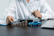 © JD8 - Blue Toy Car In Front Of Businessman Calculating Loan. Saving money for car concept, trade car for cash concept, finance concept.