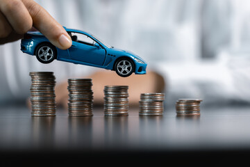 Wall Mural - Blue Toy Car In Front Of Businessman Calculating Loan. Saving money for car concept, trade car for cash concept, finance concept.