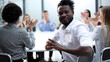 © Katsiaryna - Businesspeople laughing together during a meeting in an office