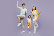 © ViDi Studio - Full body young parent mom dad with child kid daughter girl 6 years old wear blue yellow casual clothes do winner gesture celebrate raise up leg isolated on plain purple background Family day concept