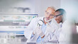 © LuneVA/peopleimages.com - Scientist, science and people, magnifying glass and plant in test tube, black woman and senior man with analysis in lab. Mentor, learn and leaves, medical research and environment study with review