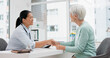 © Felix/peopleimages.com - Doctor handshake, senior woman and healthcare with thank you in a hospital for medical care. Elderly consultation, smile and insurance conversation with women in a clinic office for retirement advice