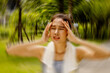 © ฺฺฺBoonterm - Asian woman exercising outdoors with discomfort hands gently massaging her head in too hot weather feeling sick dizzy fainting cerebral ischemia. Tired, supporting the body from slipping.
