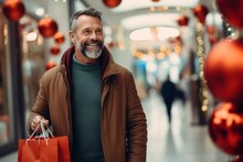 Middle Aged Smiley Caucasian Man With A Christmas Gifts In A Shopping Bags In A Mall. Christmas Sale Concept.