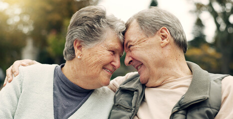 Wall Mural - Forehead, touch and senior couple in a park with love, happy and conversation with romantic bonding. Fun, old people and elderly man embrace woman with care, romance or soulmate connection outdoor