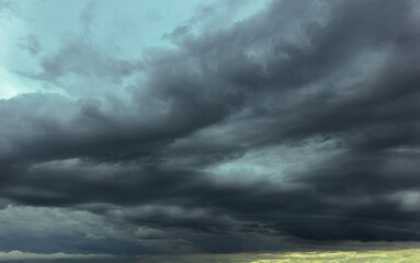 Wall Mural - The dark sky with heavy clouds converging and a violent storm before the rain.Bad or moody weather sky and environment. carbon dioxide emissions, greenhouse effect, global warming, climate change.