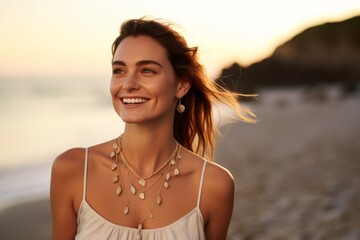 Wall Mural - Portrait of a beautiful young woman on the beach at sunset.