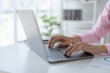 © amnaj - Close-up of hand of businesswoman working using laptop computer.