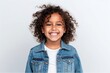 © Leon Waltz - Medium shot portrait of an Indian child female against a white background wearing a denim jacket