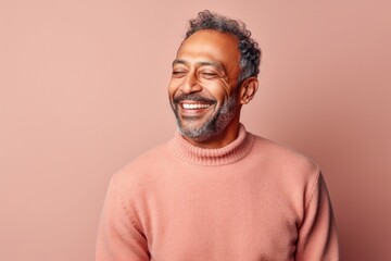 Wall Mural - Portrait of a smiling african american man in pink sweater