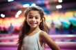 © igolaizola - smiling little girl looking at camera in amusement park with lights on background