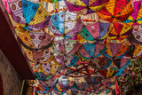 Fototapeta Na ścianę - Beautiful and extremely colorful umbrellas, from which a decorative roof was created.