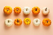 Mix of orange and white pumpkins on orange background