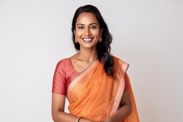 Medium shot portrait of an Indian woman in her 30s wearing traditional sari against a white background