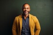 © Eber Braun - Portrait of smiling african american male teacher standing against chalkboard