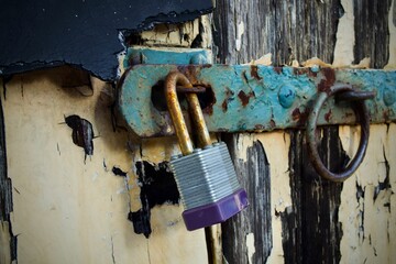 Wall Mural - Old padlock on a weathered door