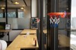 Mini basketball basket attached on the office window at WeWork company in Chicago, Illinois