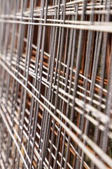 many rods hanging over a fence made of wood and steel