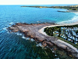 View of a stunning beach with crystal blue waters on a sunny day