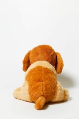 Wall Mural - Closeup of a stuffed brown dog toy on a white background