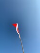indonesian flag fluttering with blue clouds background