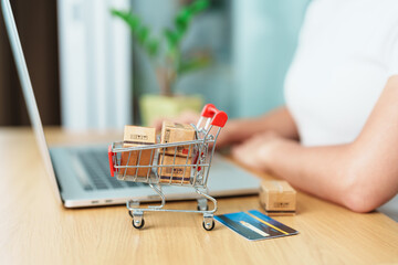 woman hand holding credit card and using laptop with mobile phone for online shopping while making order. Marketplace platform website, technology, ecommerce, shipping delivery and online payment