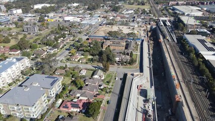 Wall Mural - Aerial drone view of the construction site of the new metro station at St Marys in Western Sydney, NSW Australia on a sunny day in August 2023 