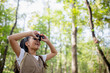 © FAMILY STOCK - Happy Little Asian girls looking ahead and smiling child with the binoculars in the park. Travel and adventure concept. Freedom, vacation