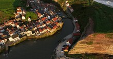 Flying Over Staithes Harbour At Sunrise.