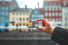 Hand Of Woman Holding Mockup Toy Colorful Houses Nyhavn Canal On Background Copenhagen, Denmark