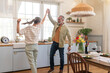 © Westend61 - Happy mature couple dancing in kitchen at home